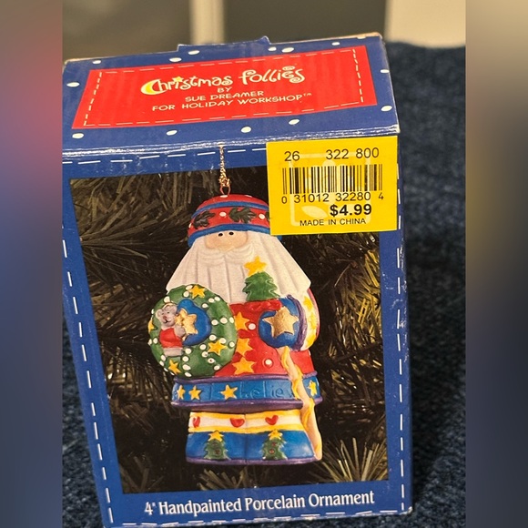 Brightly colored ceramic Santa ornament. Santa carries a tree & wreath. - Picture 8 of 10